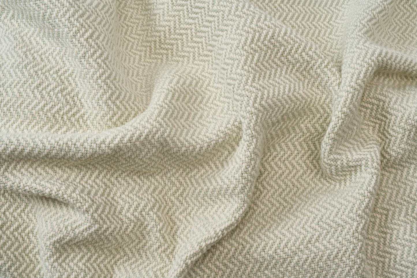 Soft beige herringbone weave cotton blanket with cozy texture for sofa or bed