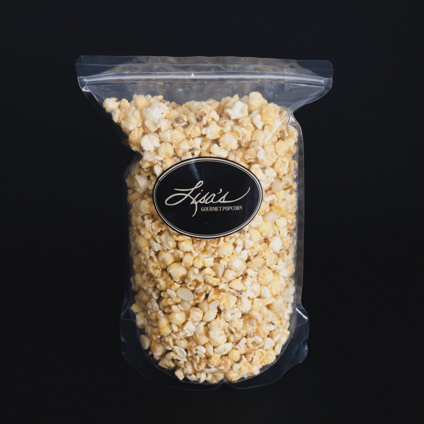 Coconut + Macadamia Nut Popcorn with candied coconut flavor and crunchy macadamia nuts in a clear resealable bag