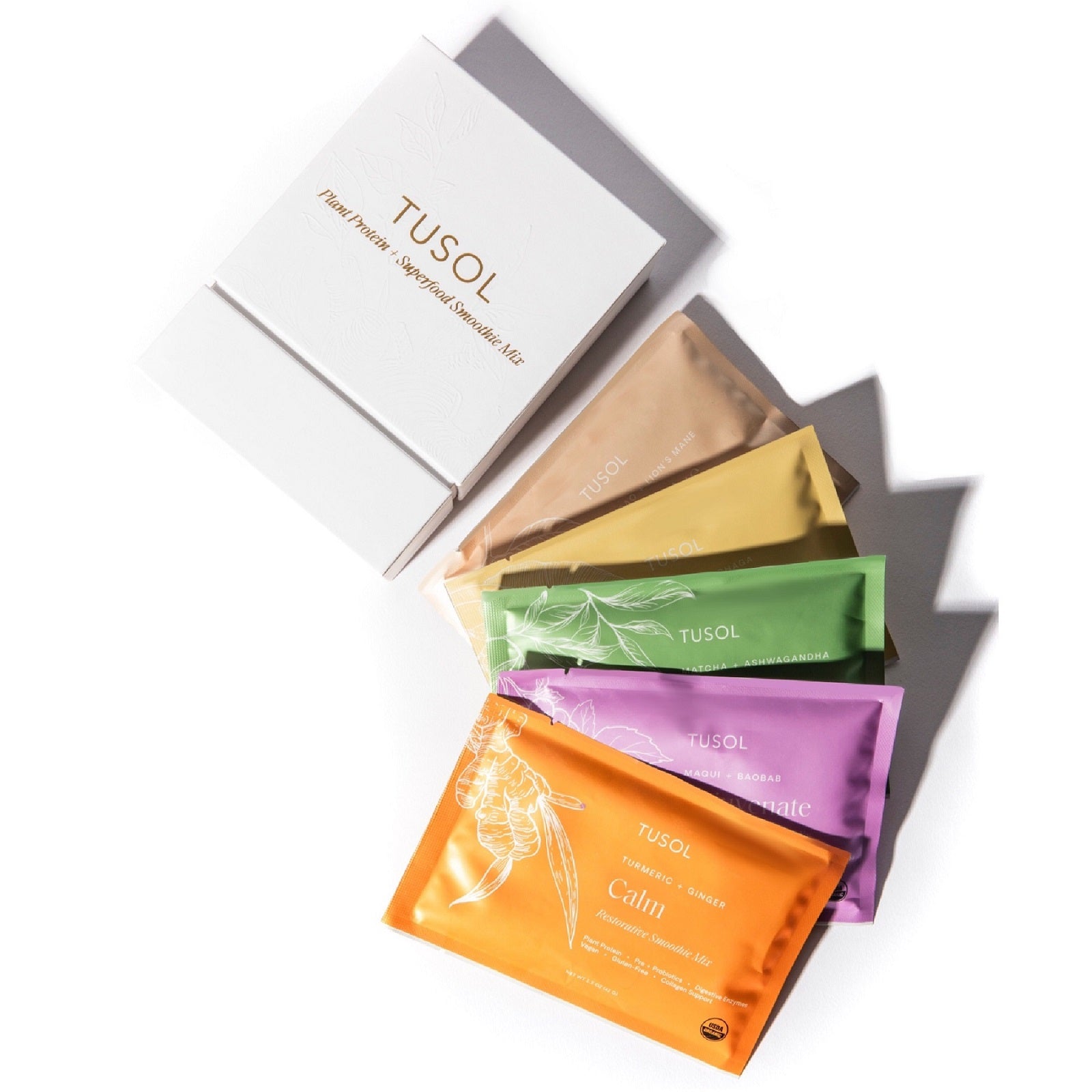 TUSOL Wellness Essentials Starter Kit with organic superfood smoothies in colorful packets and white box packaging