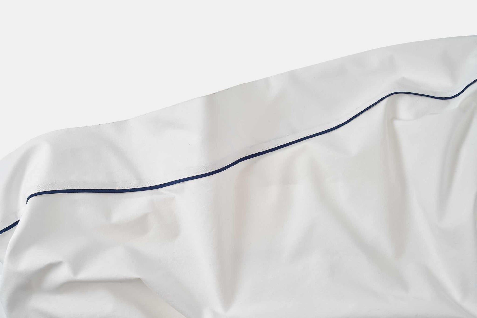 White cotton bed sheet with blue piping design detail