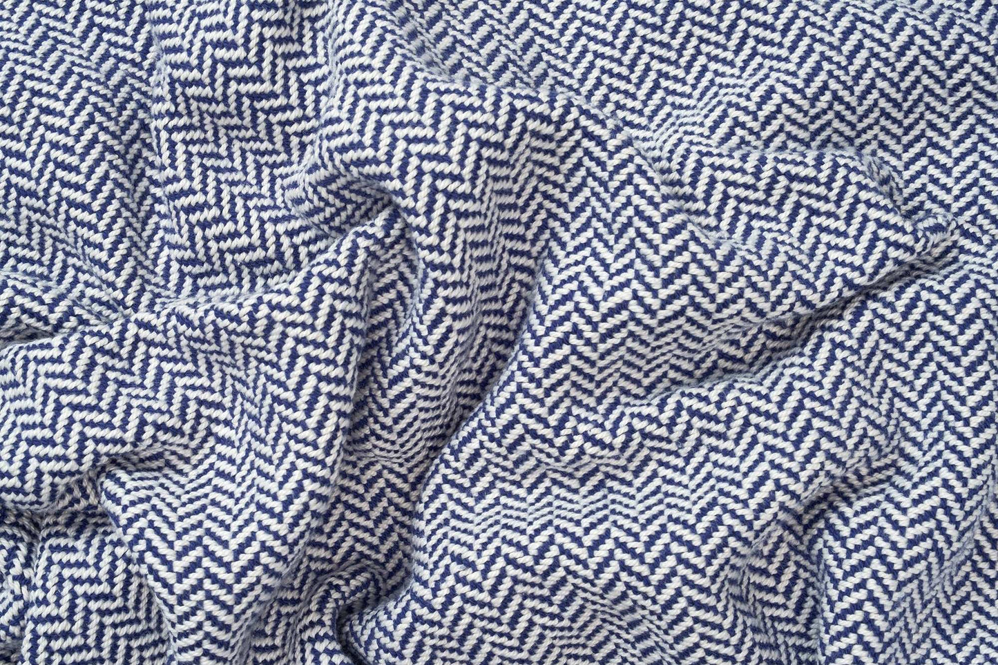 Close-up of super soft herringbone weave cotton blanket in blue and white pattern