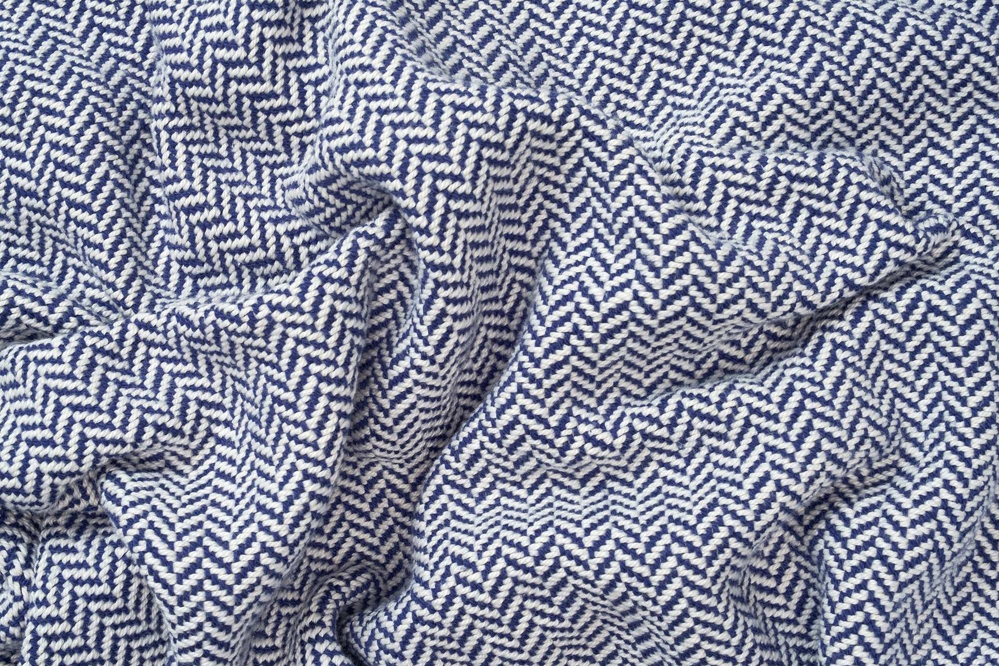 Close-up of super soft herringbone weave cotton blanket in blue and white pattern