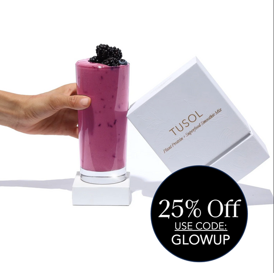 Hand holding purple berry smoothie next to Tusol Plant Protein + Superfood Smoothie Mix sample box with 25% off code GLOWUP label
