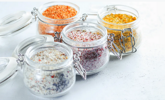 Glass jars of aromatic lavender lemon flower sugar with natural turbinado sugar and crystalized lemon honey wedge