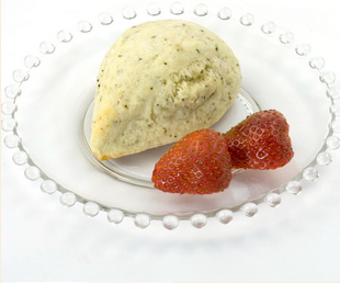 Cozy Fireside spiced chai scone served with fresh strawberries on a clear glass plate