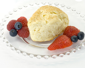 Grandma's Hill Country Scone Mix baked scone with fresh berries on a glass plate