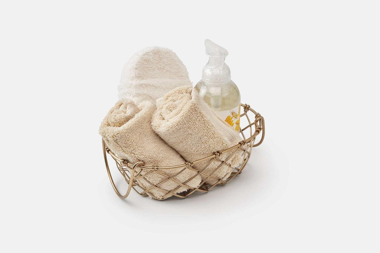 Bathroom washcloths made of luxury USA cotton with high absorbency in a wire basket with lotion bottle