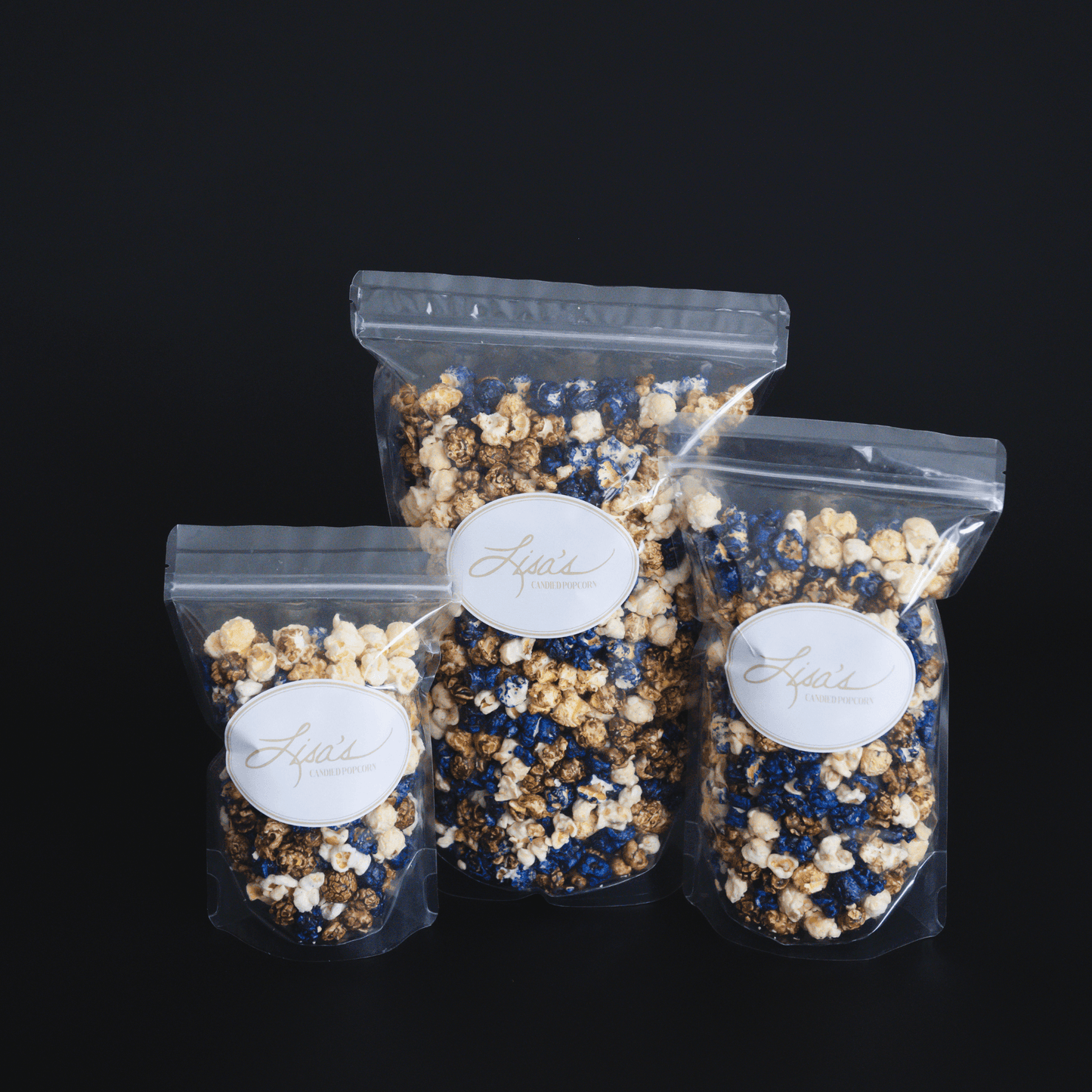 Blueberry muffin flavored popcorn mix in three clear resealable bags with white labels on black background