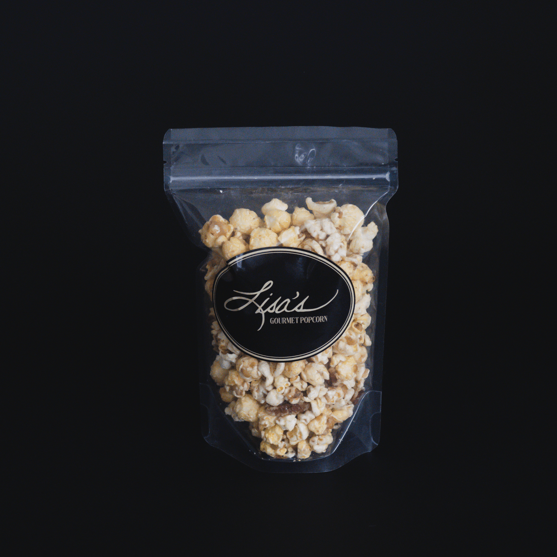 Clear resealable bag of butter pecan popcorn with crunchy pecans and buttery coating