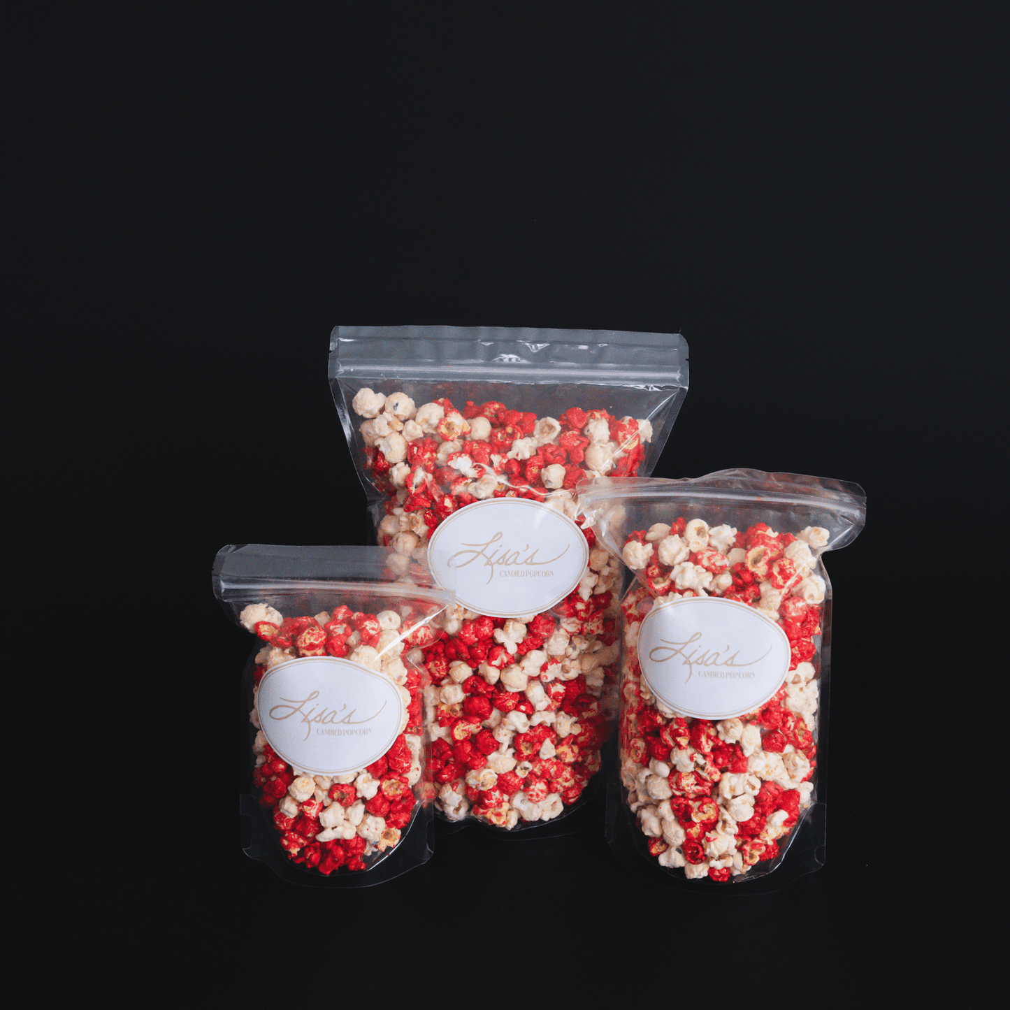 Cinnamon popcorn snack bags with sweet and spicy candied glaze in various sizes against black background