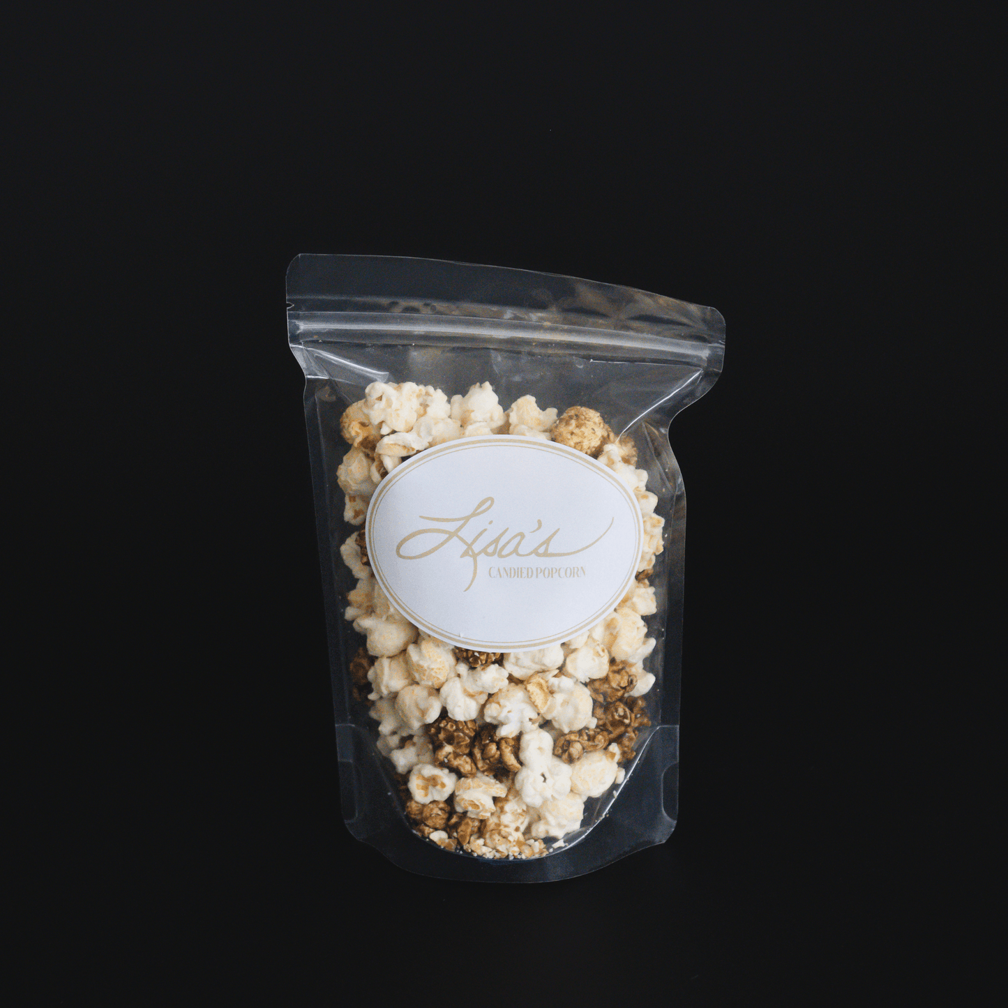 Clear resealable bag of cinnamon roll popcorn with candied cinnamon and vanilla flavors against black background