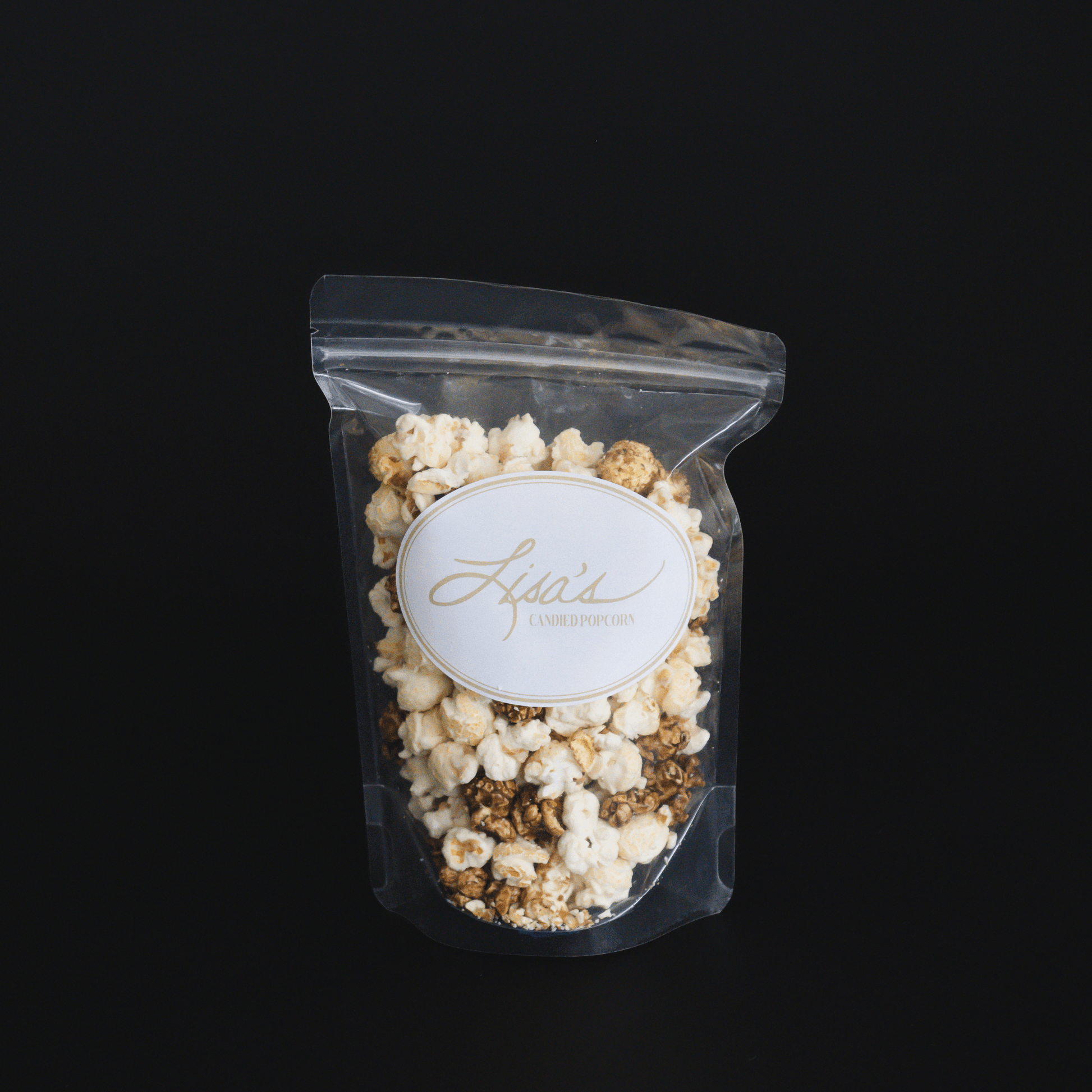 Clear resealable bag of cinnamon roll popcorn with candied cinnamon and vanilla flavors against black background