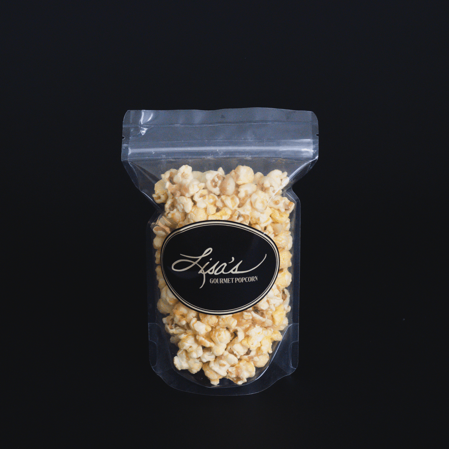 Coconut + Macadamia Nut Popcorn in clear resealable bag with black label
