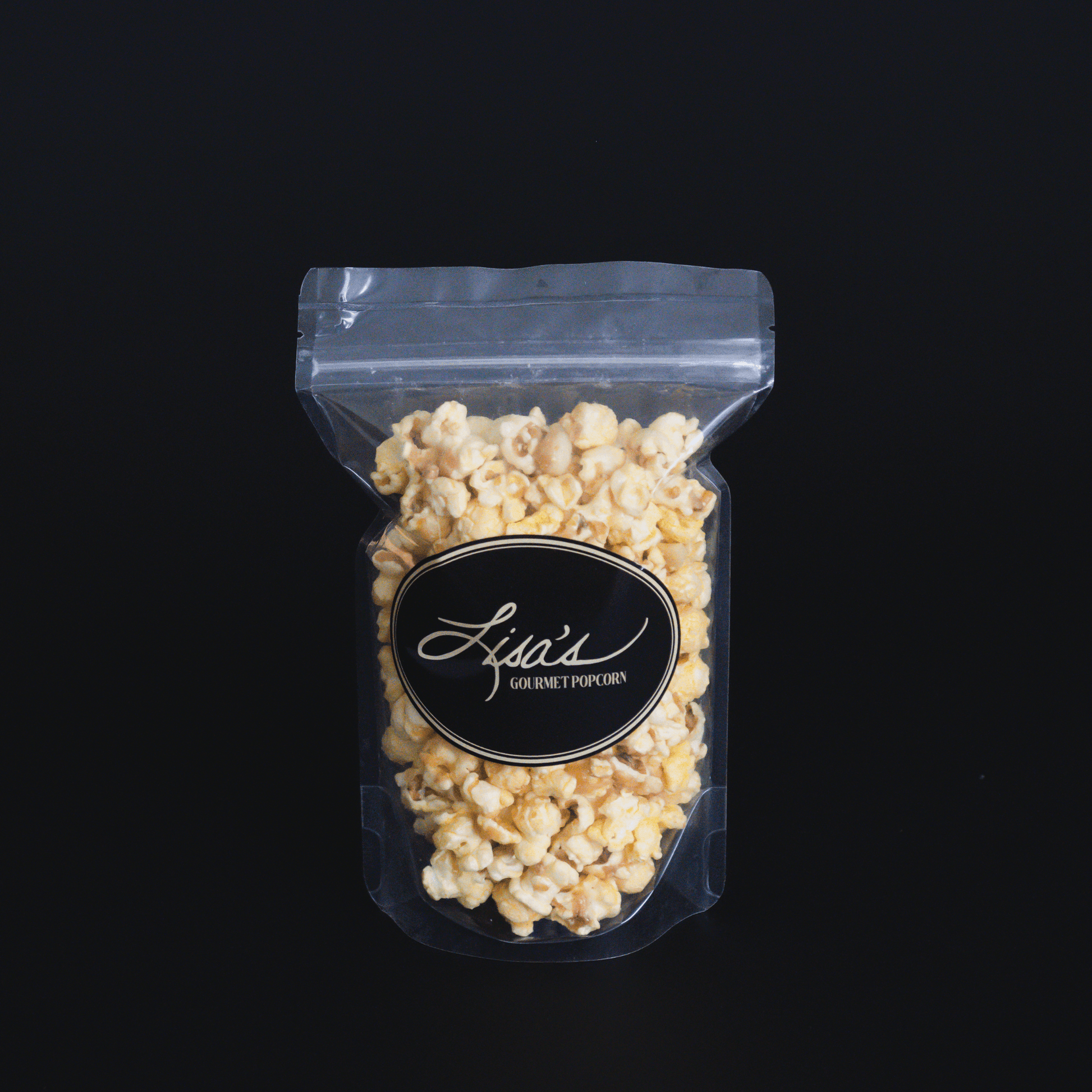 Coconut + Macadamia Nut Popcorn in clear resealable bag with black label