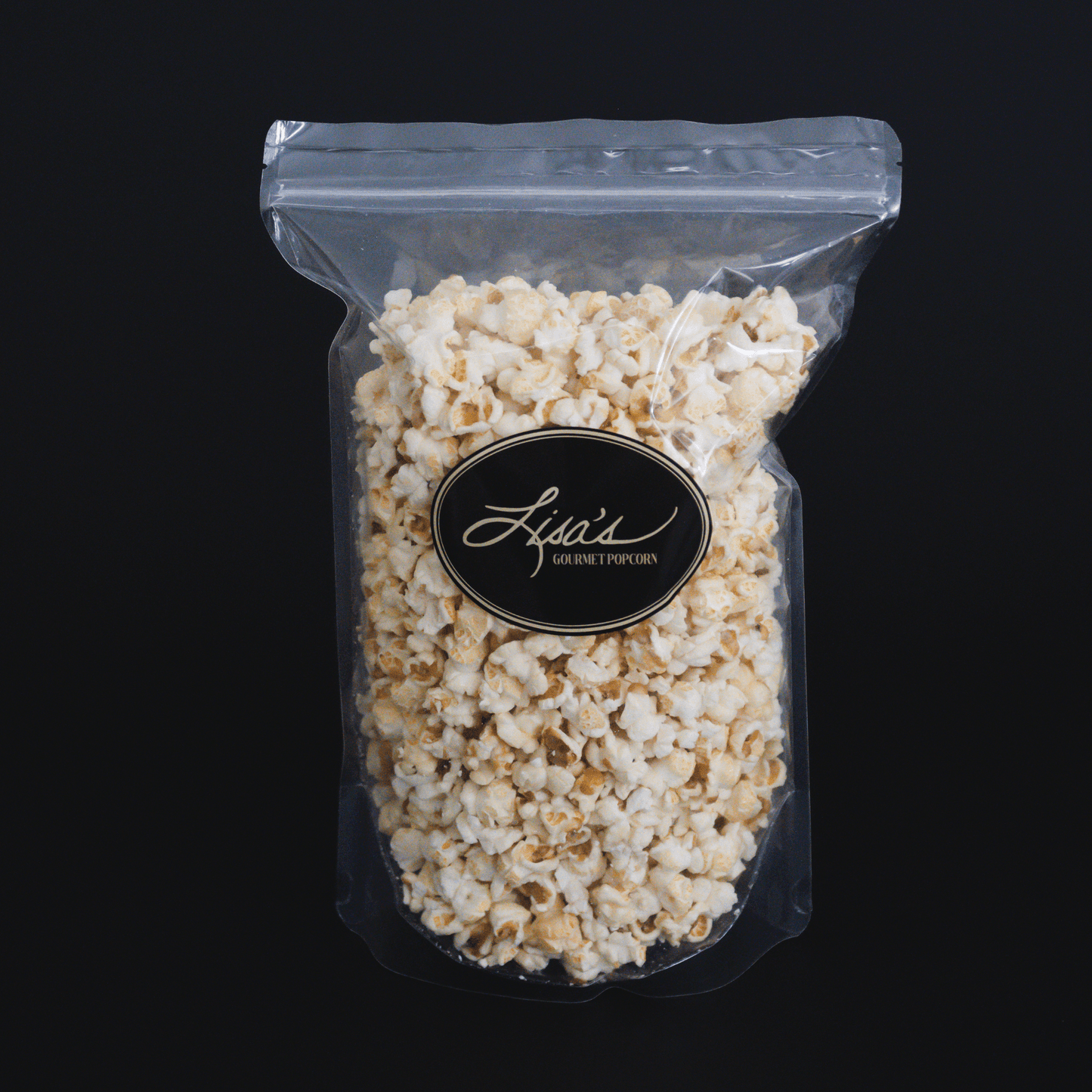 Clear resealable bag of Lisa's gourmet kettlecorn popcorn against black background
