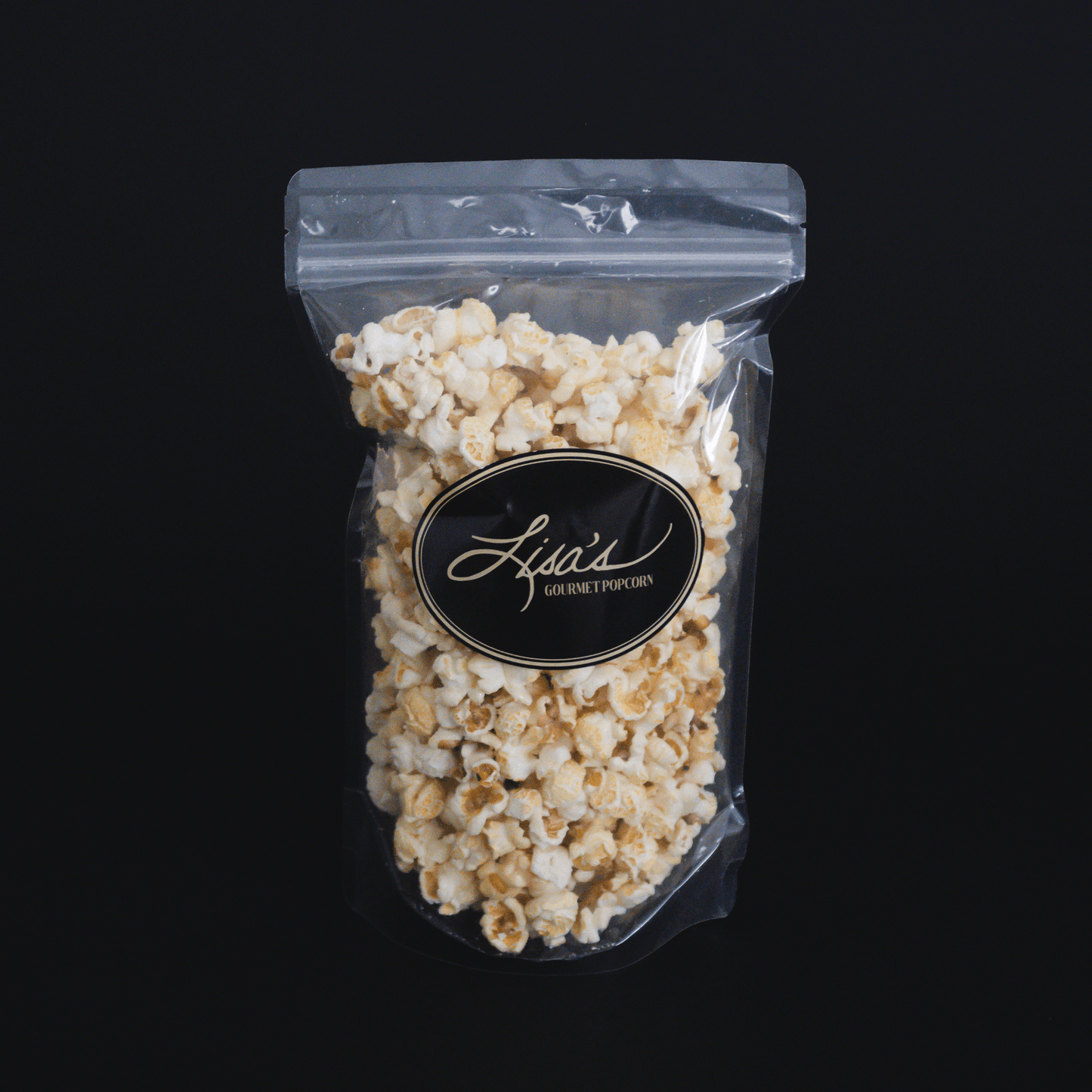 Clear resealable bag of sweet and salty kettlecorn popcorn with black and gold "Lisa's Gourmet Popcorn" label