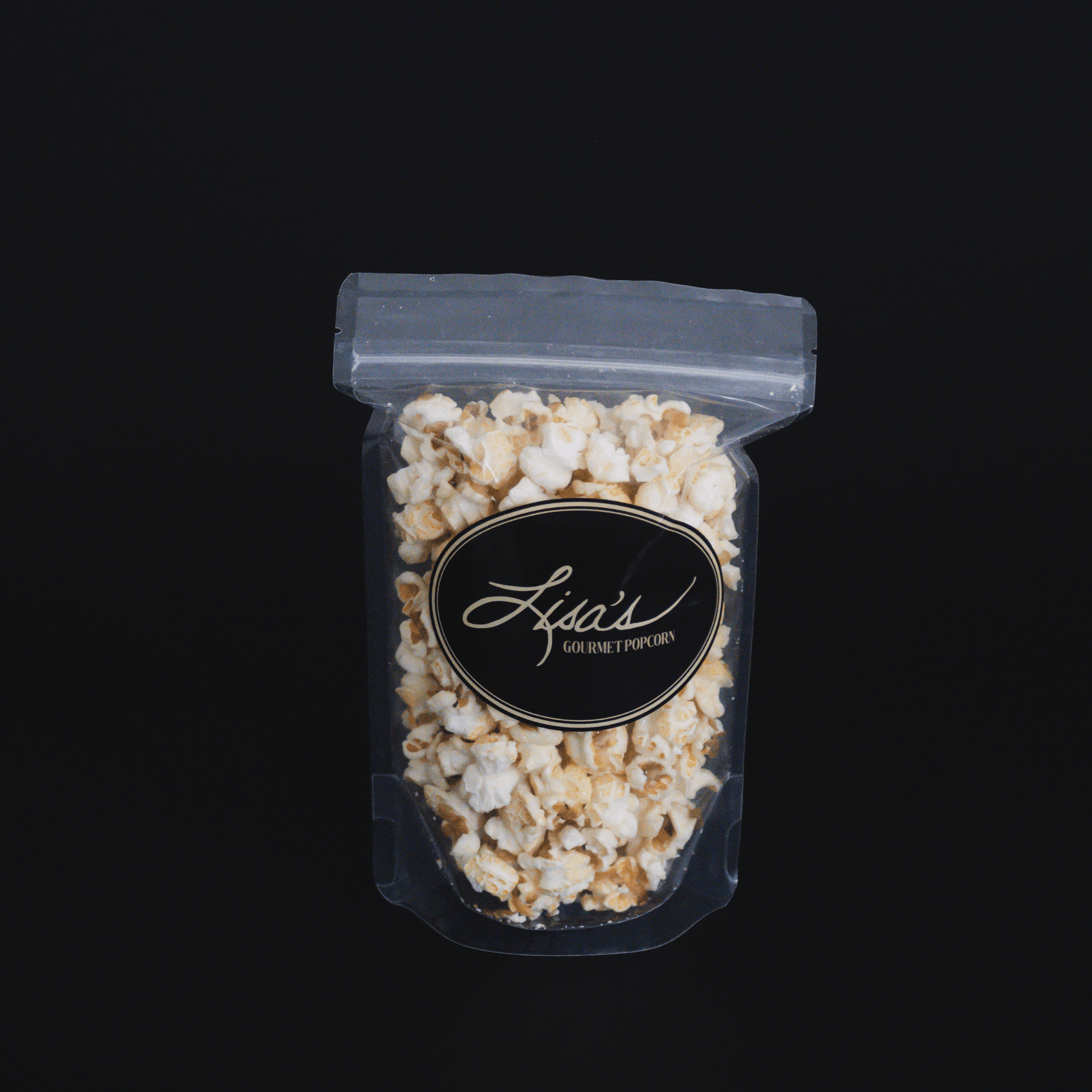 Clear resealable bag of Lisa's gourmet kettlecorn popcorn against black background