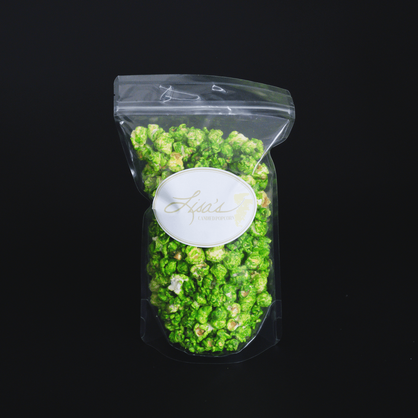 Mountain Mist Popcorn in clear resealable bag with green candied lemon and lime popcorn against black background
