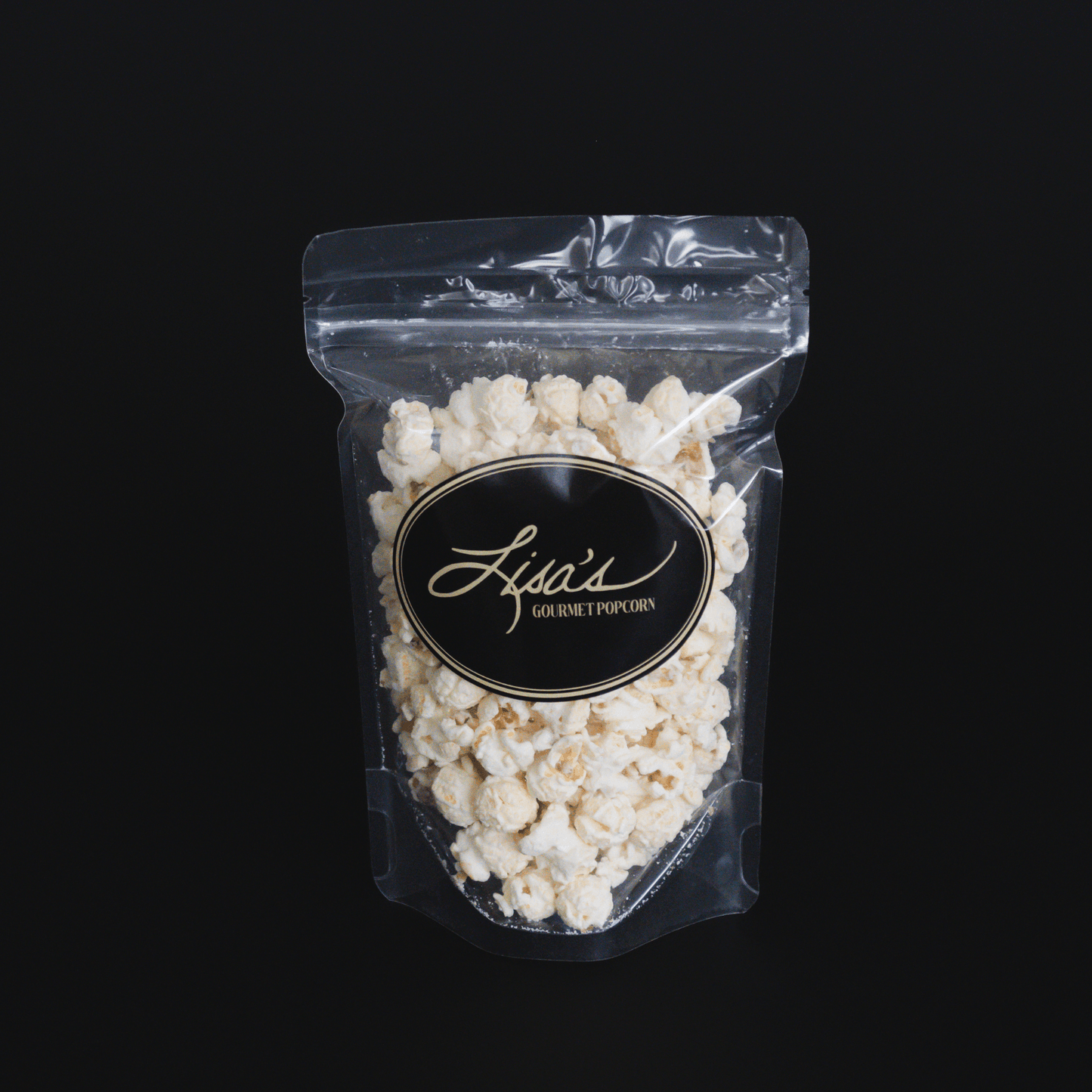 Resealable bag of gourmet white chocolate popcorn by Lisa's Gourmet Popcorn against black background